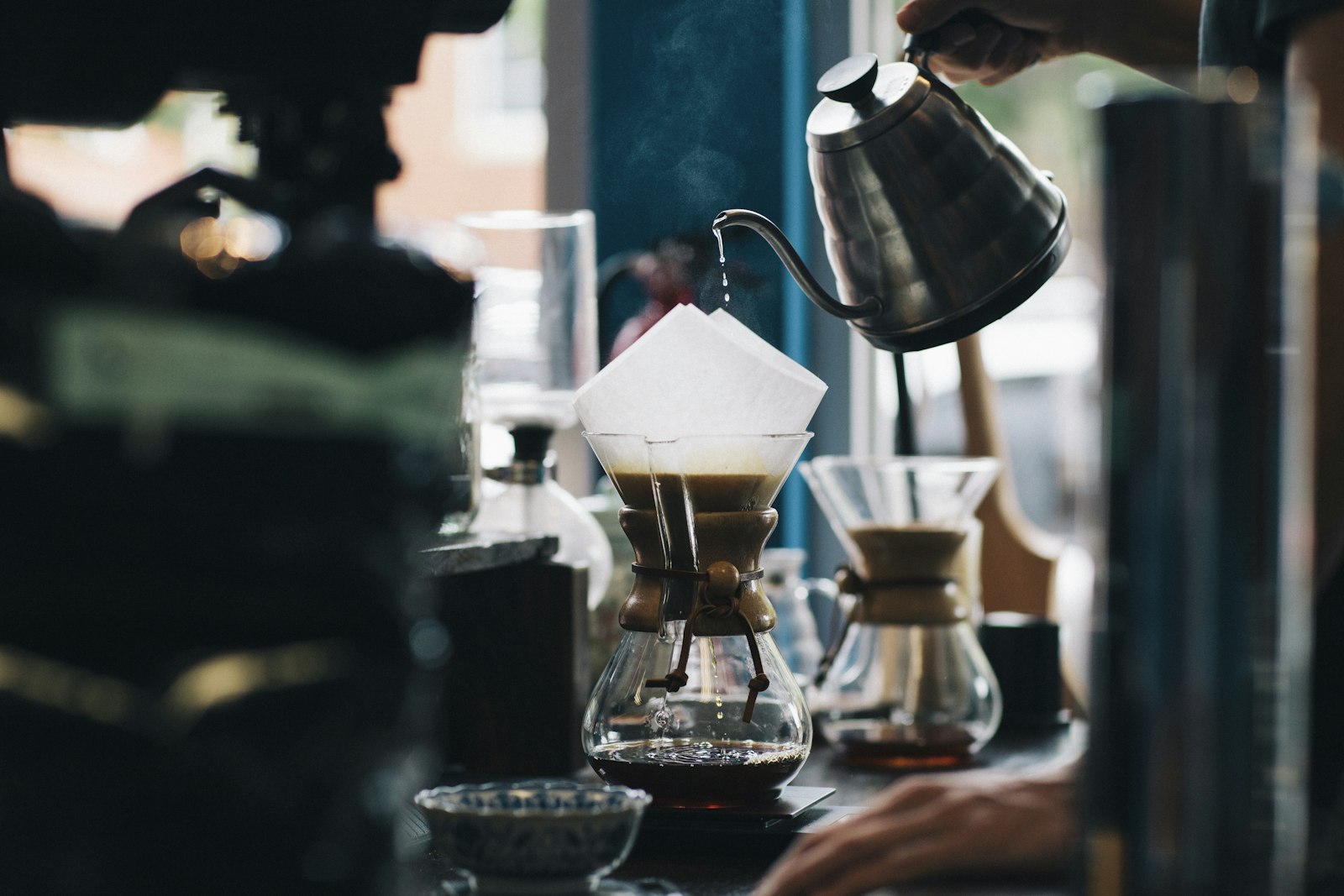 Barista carefully preparing pour-over coffee