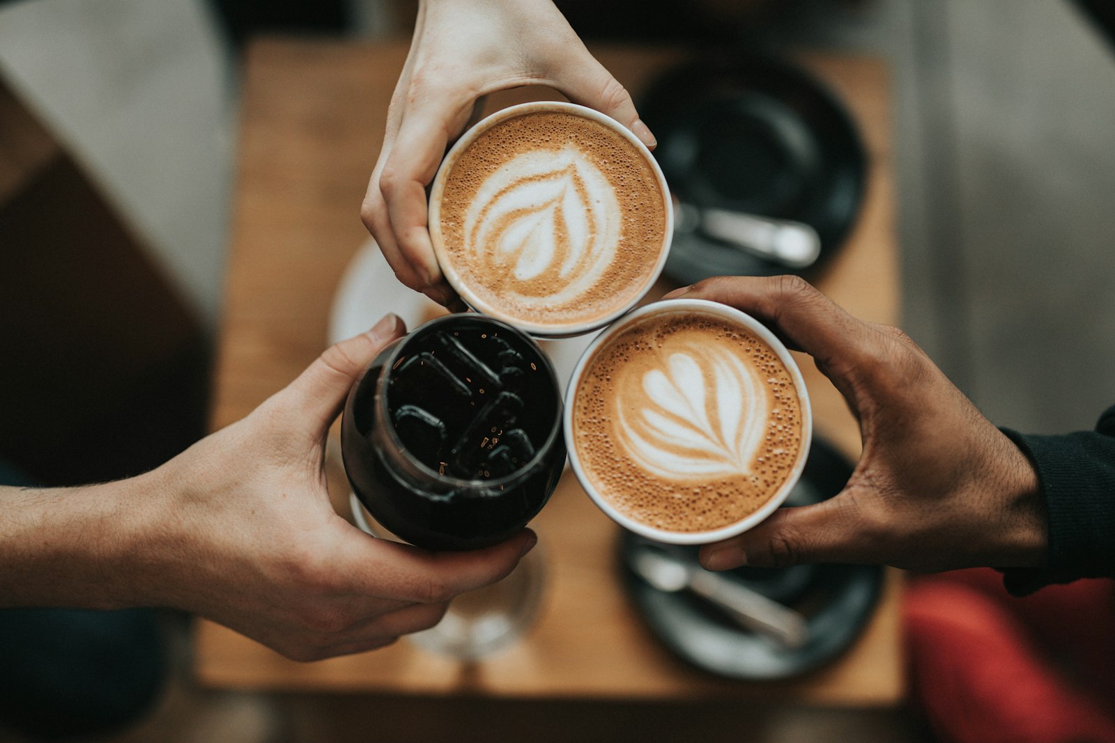 Friends sharing coffee together at a cafe table